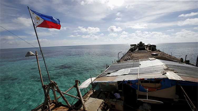 China allows Philippines to supply troops at disputed reef