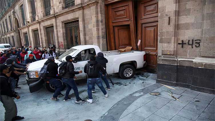 Protesters knock down door of Mexico's presidential palace
