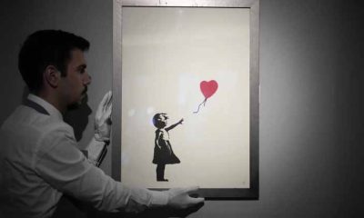 2 men charged with stealing a famous Banksy image from a London art gallery