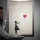 2 men charged with stealing a famous Banksy image from a London art gallery