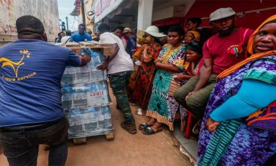 Angry residents of cyclone-hit Mayotte jeer Macron, plead for water