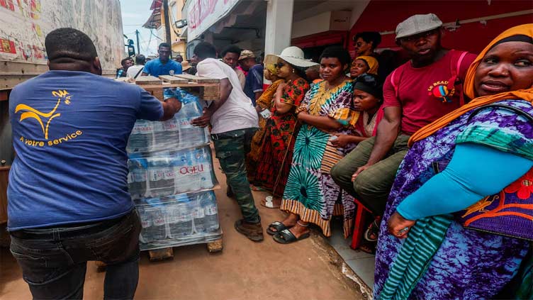 Angry residents of cyclone-hit Mayotte jeer Macron, plead for water