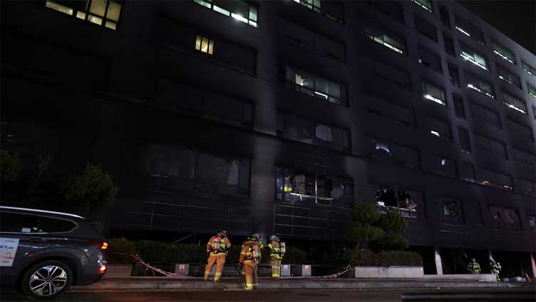 A fire and thick smoke engulfed an eight-story building in the South Korean city of Seongnam on Friday, sending 12 people to hospital with smoke inhalation, and about 30 people who had been trapped were safely rescued, the fire department said. The department deployed 82 vehicles and equipment south of Seoul to bring the blaze under control after the fire started in a restaurant on the ground floor of the busy commercial building, which also housed a swimming pool where children take lessons. Earlier, YTN television reported multiple people were trapped inside, with footage showing black smoke engulfing a large part of the building.